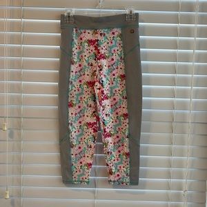 The brand is Matilda Jane. The size is 12. They are gray and flower capris.